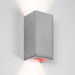 Wall light in rectangular shape made from light grey concrete with a copper coloured inside plating